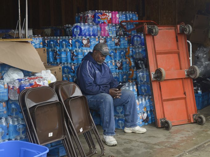 Eric Lawson takes a break from loading water into residents vehicles at St. Mark Missionary Baptist Church in Flint on Thursday, April 21, 2016. via http://www.detroitnews.com/story/news/michigan/flint-water-crisis/2016/05/02/flint-water-crisis-fatigue/83859570/