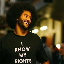 Kaepernick wearing his popular I know my rights shirt.