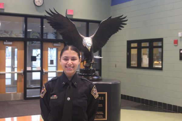 Aminah smiles next to our iconic eagle statue.