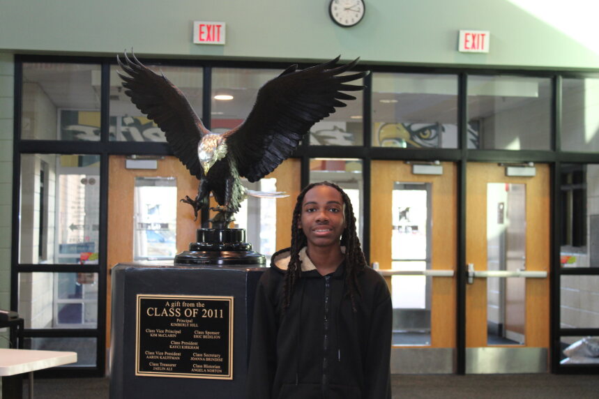 Dalyn stands with the eagle statue.