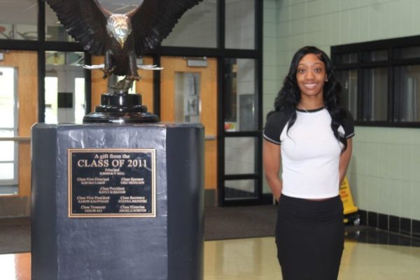 Zanyah stands professionally with the Eagle statue.